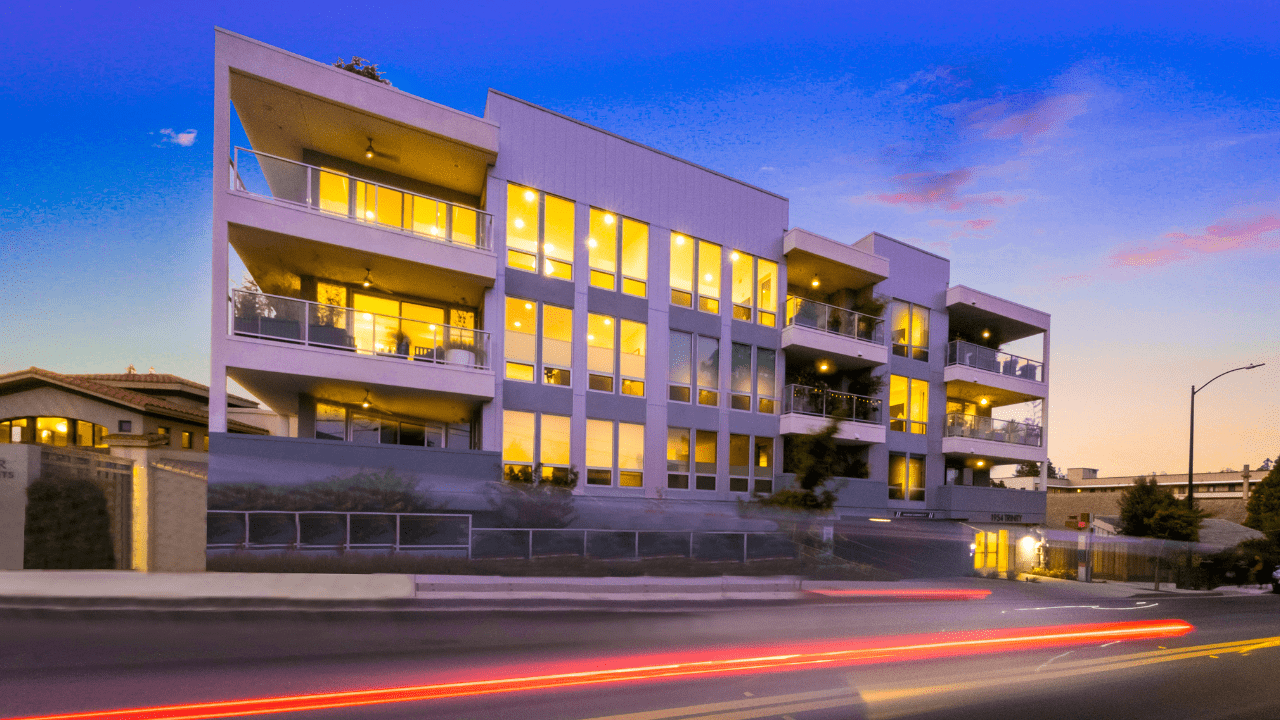 Modern building with illuminated windows at dusk.