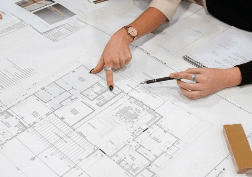 Architects reviewing building floor plan documents.