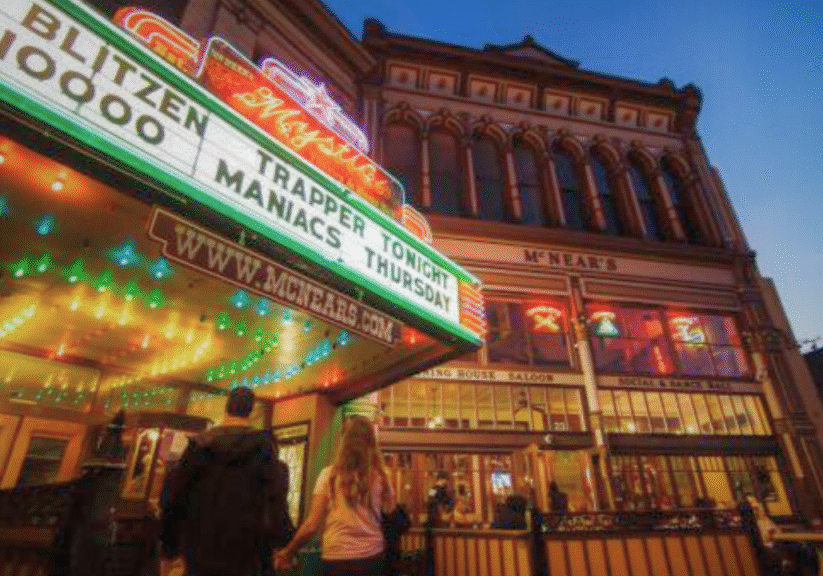 Couple outside McMenamins theater at dusk. Couple outside McMenamins theater at dusk.
